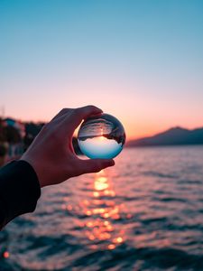 Preview wallpaper crystal ball, ball, hand, sunset, reflection