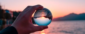 Preview wallpaper crystal ball, ball, hand, sunset, reflection