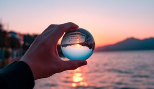 Preview wallpaper crystal ball, ball, hand, sunset, reflection