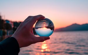 Preview wallpaper crystal ball, ball, hand, sunset, reflection