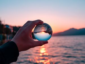 Preview wallpaper crystal ball, ball, hand, sunset, reflection