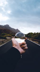 Preview wallpaper crystal ball, ball, hand, road, reflection