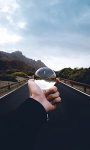 Preview wallpaper crystal ball, ball, hand, road, reflection