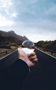 Preview wallpaper crystal ball, ball, hand, road, reflection