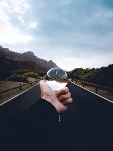 Preview wallpaper crystal ball, ball, hand, road, reflection