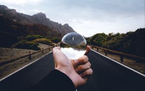 Preview wallpaper crystal ball, ball, hand, road, reflection