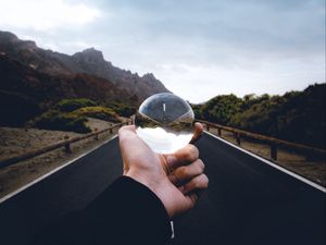 Preview wallpaper crystal ball, ball, hand, road, reflection