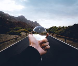 Preview wallpaper crystal ball, ball, hand, road, reflection
