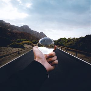 Preview wallpaper crystal ball, ball, hand, road, reflection