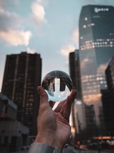 Preview wallpaper crystal ball, ball, hand, reflection, city, buildings