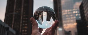 Preview wallpaper crystal ball, ball, hand, reflection, city, buildings