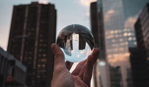 Preview wallpaper crystal ball, ball, hand, reflection, city, buildings