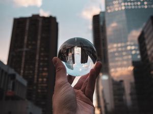 Preview wallpaper crystal ball, ball, hand, reflection, city, buildings