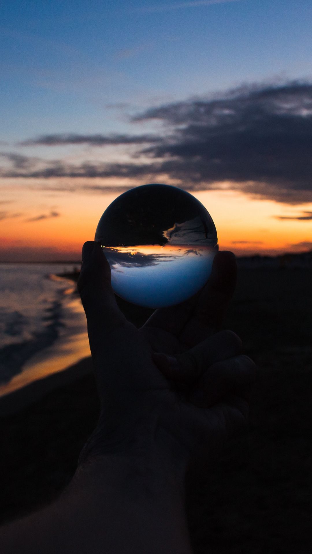 Download wallpaper 1080x1920 crystal ball, ball, hand, sunset, dusk ...