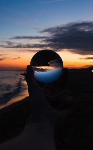 Preview wallpaper crystal ball, ball, hand, sunset, dusk, dark