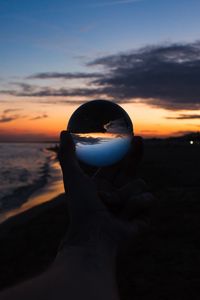 Preview wallpaper crystal ball, ball, hand, sunset, dusk, dark