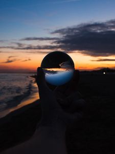 Preview wallpaper crystal ball, ball, hand, sunset, dusk, dark