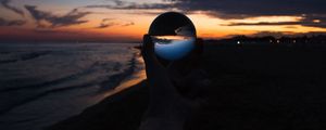 Preview wallpaper crystal ball, ball, hand, sunset, dusk, dark