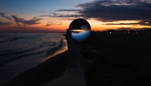 Preview wallpaper crystal ball, ball, hand, sunset, dusk, dark