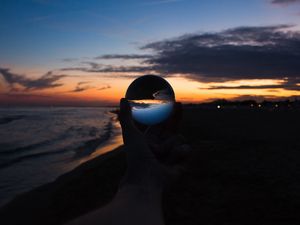 Preview wallpaper crystal ball, ball, hand, sunset, dusk, dark