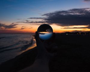 Preview wallpaper crystal ball, ball, hand, sunset, dusk, dark