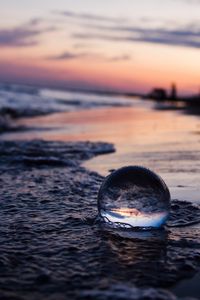 Preview wallpaper crystal ball, ball, reflection, beach, sea, sunset