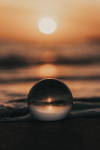 Preview wallpaper crystal ball, ball, sunset, beach, sea