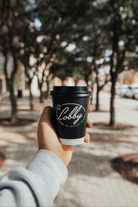 Preview wallpaper cup, black, inscription, hand