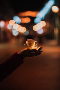 Preview wallpaper cup, garland, hands, glow, night