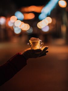 Preview wallpaper cup, garland, hands, glow, night