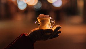 Preview wallpaper cup, garland, hands, glow, night