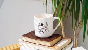 Preview wallpaper cup, inscription, books, plant, shadow