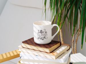 Preview wallpaper cup, inscription, books, plant, shadow