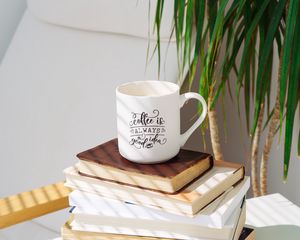 Preview wallpaper cup, inscription, books, plant, shadow