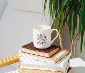 Preview wallpaper cup, inscription, books, plant, shadow