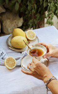 Preview wallpaper cup, lemon, hands, rings, tablecloth