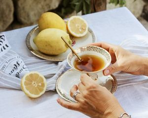 Preview wallpaper cup, lemon, hands, rings, tablecloth