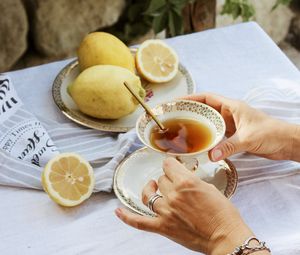 Preview wallpaper cup, lemon, hands, rings, tablecloth