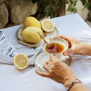 Preview wallpaper cup, lemon, hands, rings, tablecloth