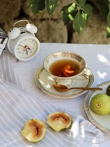 Preview wallpaper cup, tea, figs, alarm clock, tablecloth