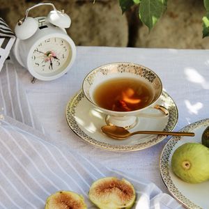 Preview wallpaper cup, tea, figs, alarm clock, tablecloth