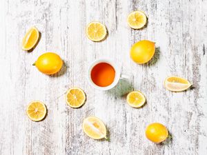 Preview wallpaper cup, tea, lemons, slices, citrus