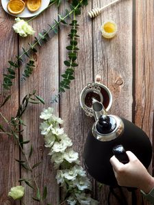 Preview wallpaper cup, teapot, tea, hand, flowers