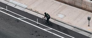 Preview wallpaper cyclist, bicycle, road, street