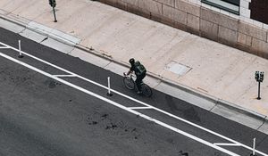 Preview wallpaper cyclist, bicycle, road, street