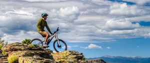 Preview wallpaper cyclist, bike, rock, cliff, nature