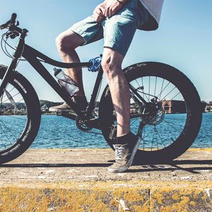 Preview wallpaper cyclist, legs, bicycle, river