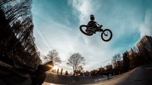 Preview wallpaper cyclist, trick, bicycle, helmet, sky