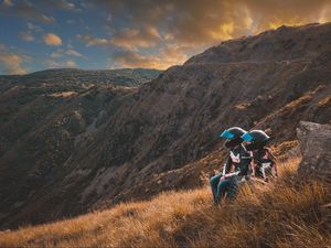 Preview wallpaper cyclists, couple, mountains, helmet, grass, trip