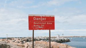 Preview wallpaper danger, sign, shore, stones